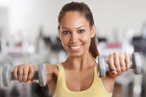 Woman working out with dumbbells.